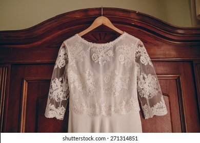 Vintage Wedding Dress With Lace On An Old Wooden Cabinet