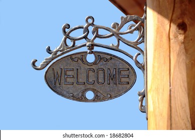 A Vintage Welcome Sign On A Log Structure