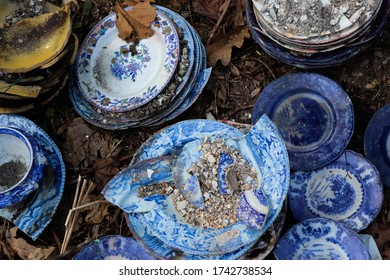 Vintage White And Blue Dishes Salvaged From A House Fire Outside On The Ground