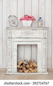 Vintage White Fireplace With Firewood And Lamp