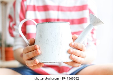 Vintage White Watering Can In Hands Close-up. Plant Care Concept, Lifestyle, Gardening, Hobby. Spring Card.  Plant Flower Shop. Mockup, Copy Space. Selective Focus.