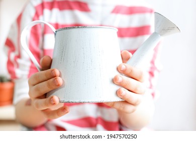 Vintage White Watering Can In Hands Close-up. Plant Care Concept, Lifestyle, Gardening, Hobby. Spring Card.  Plant Flower Shop. Mockup, Copy Space. Selective Focus.