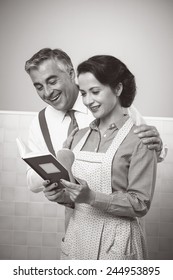 Vintage Wife And Husband Reading A Cookbook Together At Home