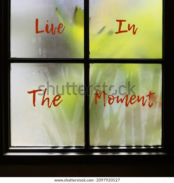 Vintage window with\
text LIVE IN THE MOMENT, concept of live with the present - be with\
the NOW not past or future, control anxiety - not to worry about\
yesterday or tomorrow
