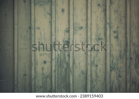 vintage wood background texture with knots and nail holes. painted wooden board showing cracked paint. Old green wooden wall with cracked paint, background texture. vintage background peeling paint.