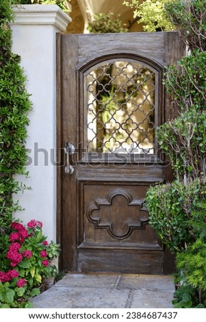 Vintage wood garden gate with decorative wrought iron