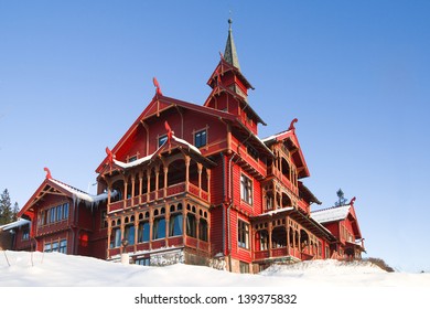 Vintage wood hotel in Oslo, Norway, with snow in a sunny day.