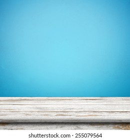 Vintage Wood Table In Blue Wall Room.