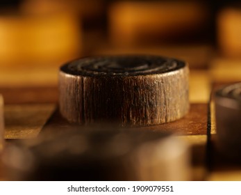 Vintage wooden checkerboard with brown and cream colored checkers. - Shutterstock ID 1909079551