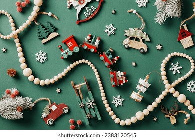 Vintage wooden Christmas toys and garland on green background. Flat lay, top view. - Powered by Shutterstock