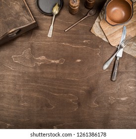 Vintage wooden cutlery and tray on a brown wooden background. Copy space. - Shutterstock ID 1261386178