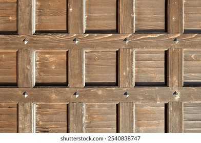 Vintage wooden door - metal rivets on the old brown wooden surface. Architecture background with old wooden door made of natural wood - Powered by Shutterstock