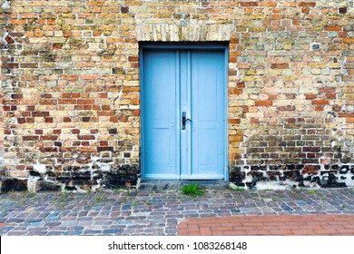 Vintage wooden door on old brick wall background