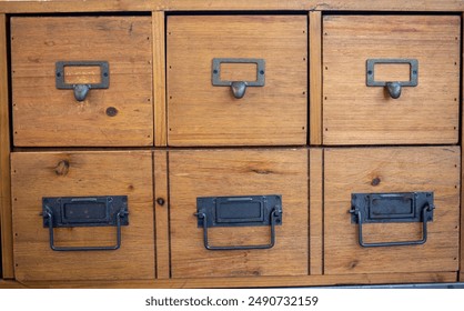 a vintage wooden filing cabinet with metal handles showing rustic charm and organizational utility. Explore handmade, solid office that combines durability with artisanal charm - Powered by Shutterstock