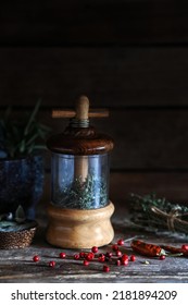 Vintage Wooden Herb Grinder With Mixed Herbal Ingredient From Thyme, Sage, Red Chilli Pepper On Wooden Board - Dark And Moody Photography