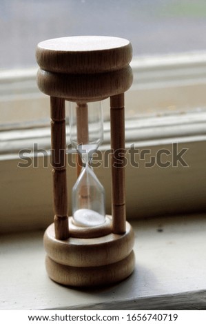 vintage wooden hour glass with running sand