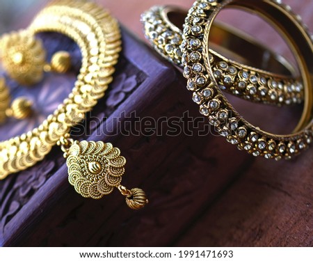 Vintage wooden jewellery box with Indian traditional jewelry, Golden pair of earrings, gold diamond bracelet Luxury female jewelry, Indian traditional jewellery,Bridal Gold wedding jewellery