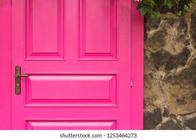 vintage wooden pink door with metal furniture