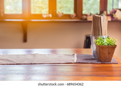 Vintage wooden table decorated with cloth and little tree and napkin. Concept of retro style coffee cafe table
