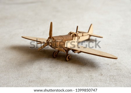 Vintage wooden toy plane isolated on texture background. Made from pine.