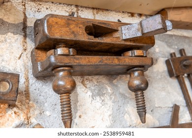 A vintage woodworking clamp made out of wood, and a wood planer. - Powered by Shutterstock