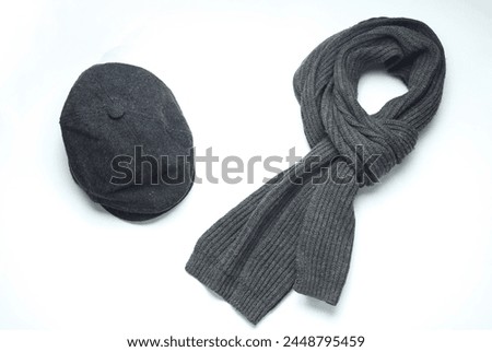 Vintage woolen English eight-piece cap with scarf on a white background. Gentleman's accessories