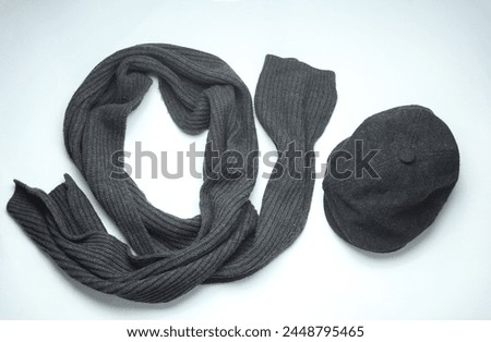 Vintage woolen English eight-piece cap with scarf on a white background