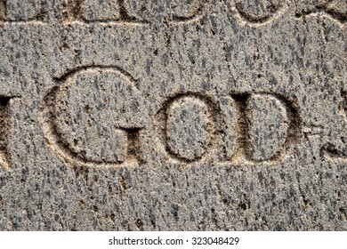 Vintage word GOD sign on the gray concrete wall