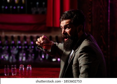 Vintage Worker Man With Long Beard Holding Whiskey. Sitting In Bar