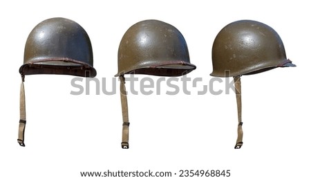 Vintage World War II United States army helmets at various angles isolated on a white background