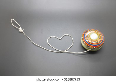 Vintage yoyo with twine rolling in heart shape