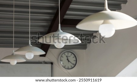 A vintagestyle clock, elegantly hanging from the ceiling of the room, clearly shows the time as precisely 420 in the afternoon hour