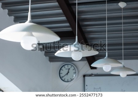 A vintagestyle clock, elegantly hanging from the ceiling of the room, clearly shows the time as precisely 420 in the afternoon hour