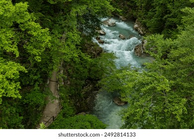 Vintgar Gorges Park a few km from Lake Bled, Slovenia. Wooden walkways accompany the path above the river rapids and waterfalls. River hits rocks and creates fog.Adventure family holidays. Freshness. - Powered by Shutterstock