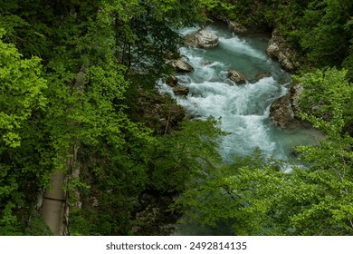 Vintgar Gorges Park a few km from Lake Bled, Slovenia. Wooden walkways accompany the path above the river rapids and waterfalls. River hits rocks and creates fog.Adventure family holidays. Freshness. - Powered by Shutterstock
