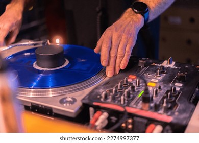 Vinyl DJ using blue vinyl djing