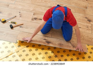 vinyl floor installation. Close-up hands of worker at home flooring renovation. - Shutterstock ID 2238903849