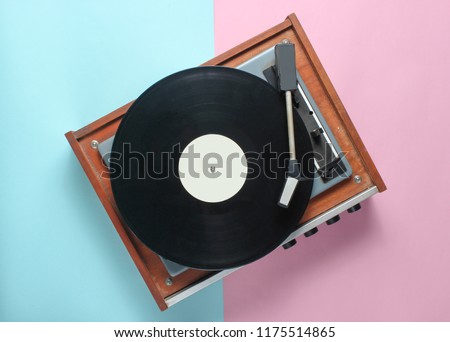 Vinyl player on a blue pink pastel background. Top View