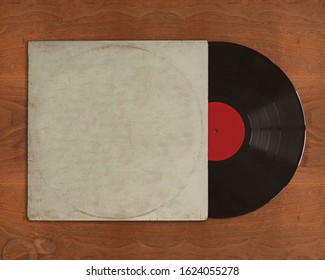 Vinyl record with blank cover on wooden background and copy space