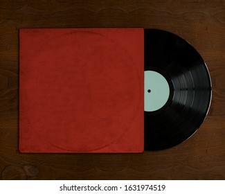 Vinyl record with cover on wooden table top view