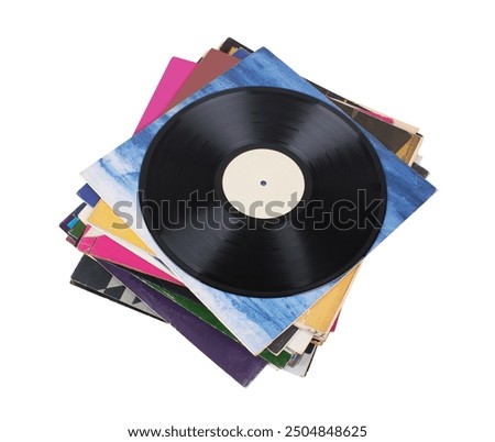 Vinyl record on a stack paper envelopes. Analog sound. Classic audio. Isolated on white background