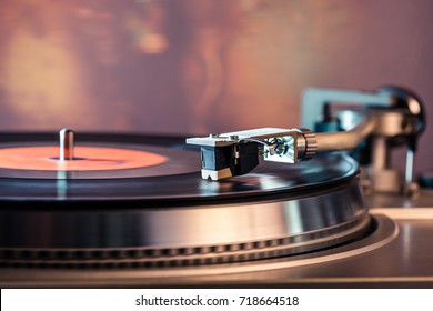 Vinyl record player, bright lights disco-bokeh. Needle on vinyl record. - Shutterstock ID 718664518