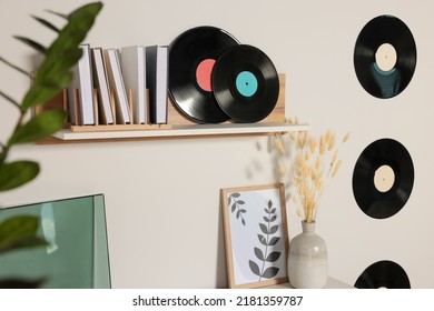 Vinyl Records With Books And Wooden Shelf On White Wall