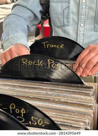 Vinyl records stack, LPs flea market, browsing music collection, secondhand vinyl sale, weekend street market, music lover search unique vintage treasures, collectors browsing items, treasure hunting