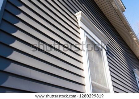 vinyl siding and new windows on residential home; real estate background concept with space for text