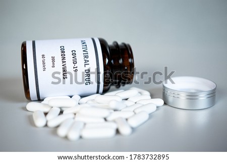 Viol and scattered antiviral Coronavirus COVID-19 pills. Coronavirus Covid 19 tablets for infection treatment against covid19. Healthcare and medical concept.