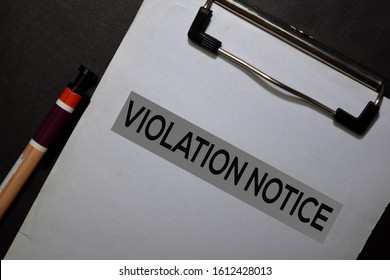 Violation Notice write on a paperwork isolated on black table.