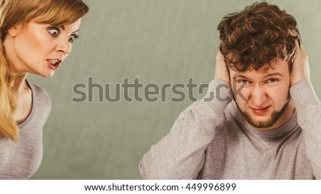 Violence against man. Aggressive woman yelling shouting on scared afraid man. Negative relations in partnership. Expressive young lady screaming.