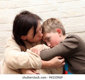 Violence  in the family. Mother  soothes her son