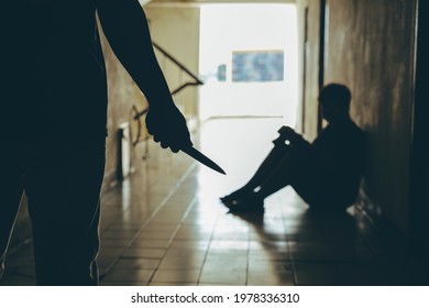 Violent Man Carries A Knife Attempting To Attack A Young Man In Front Of The Room.Domestic Violence Problems Concept.